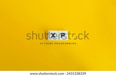 Extreme Programming (XP) Acronym and Term. Software Development Methodology. Text on Block Letter Tiles on Yellow Background.