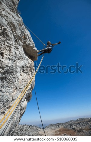 Similar – Image, Stock Photo Rock climber clinging to a cliff.