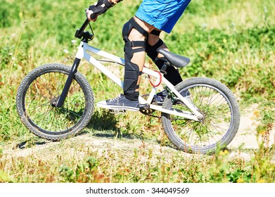 Extreme Sport Concept. Young Cyclist Riding The Mountain Bike Uphill Or Cross-country Course