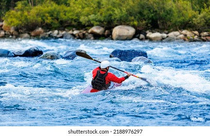 Extreme sport kayaker, back view man in boat kayak whitewater rafting, blue water.