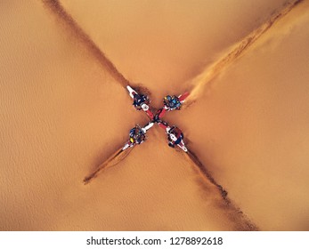 Extreme Sport. Motorbikes In Desert Making X Sign On Sand Top View. Extreme Riding On Motorcycles