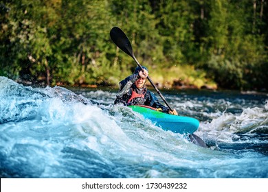 Extreme Sport Rafting Whitewater Kayaking. Guy In Kayak Sails Mountain River.