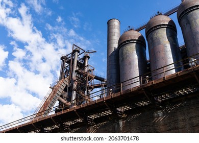 Extreme Upward View Of Blast Furnaces And Structures Of An Abandoned Steel Mill Exterior, Blue Sky With Clouds, Horizontal Aspect