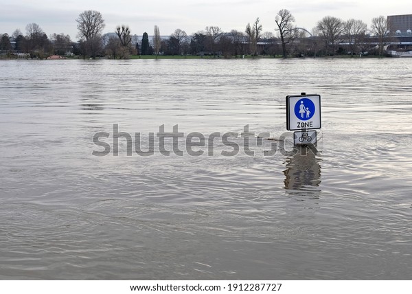 Extreme weather: Street signs in a flooded\
pedestrian zone in Cologne,\
Germany