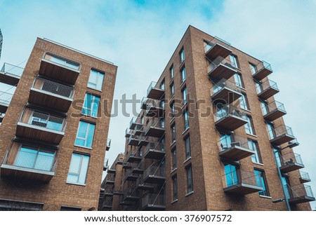 Apartment building with balconies and orange brick walls