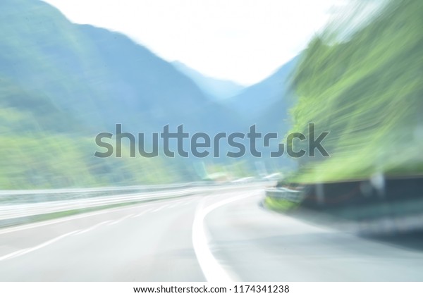 extremely blurred and defocused motion\
picture of a road in the\
countryside