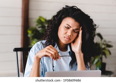 Extremely Exhausted Young African Businesswoman Suffering From Headache At The Workplace. Lazy Apathetic Black Female University Student Frustrated About Study Computer Work Feeling Demotivated