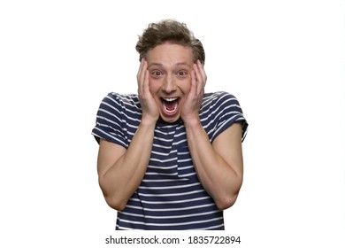 Extremely Happy Shocked Young Guy With Opened Mouth. Astonished Teen Boy's Touching His Face Isolated On White Background.