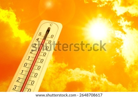 Extremely high temperature on thermometer against orange sky on sunny day. Severely hot summer weather