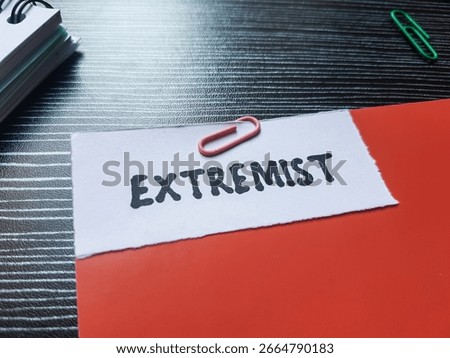 Extremist writting on table background.