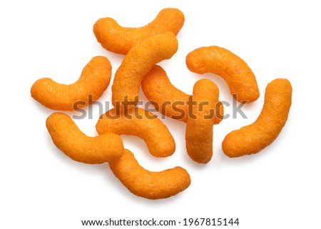 Extruded cheese puffs isolated on white. Top view.