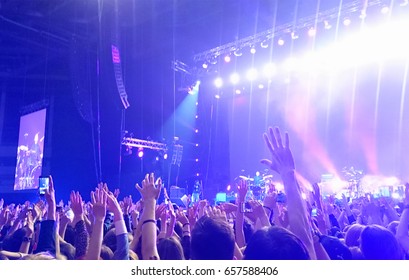 Exulting Crowd With Raised Nands During Concert At The Stadium