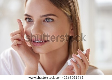 Eye care. Smiling Woman With Contact Eye Lens on Finger Closeup. Portrait of Beautiful Blonde Girl Putting Contacts Lenses in Eyes. Vision Health Concept 