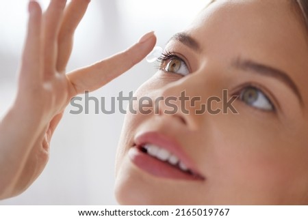 Eye care. Smiling Woman With Contact Lens on Finger Closeup. Smiling Lady with Contact Eye Lenses in Hand. Girl Applying Eye Contacts. Eye Health Care Concept