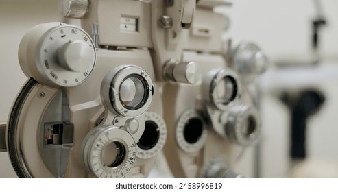 Eye care, test and phoropter in clinic for vision, specialist and healthcare for optical lens. Prescription, optometry and ophthalmic machine for medical, exam and check up and results in store. - Powered by Shutterstock