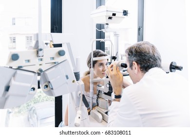 Eye Doctor Examinating A Young Patient