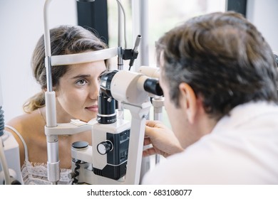 Eye Doctor Examinating A Young Patient