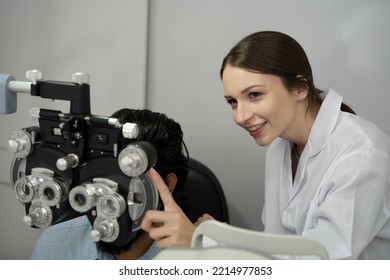 An Eye Doctor Examines A Male Patient In A Clinic With Modern Equipment.