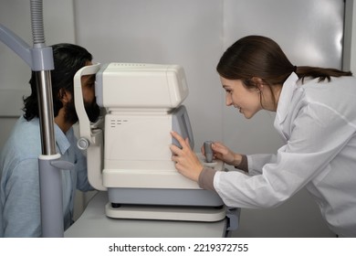 An Eye Doctor Examines A Male Patient In A Clinic With Modern Equipment.