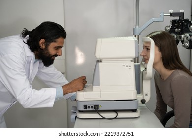 An Eye Doctor Examines A Woman Patient In A Clinic With Modern Equipment.