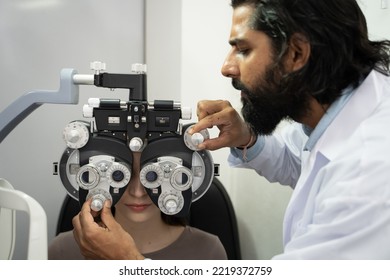 An Eye Doctor Examines A Woman Patient In A Clinic With Modern Equipment.