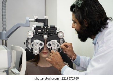 An Eye Doctor Examines A Woman Patient In A Clinic With Modern Equipment.