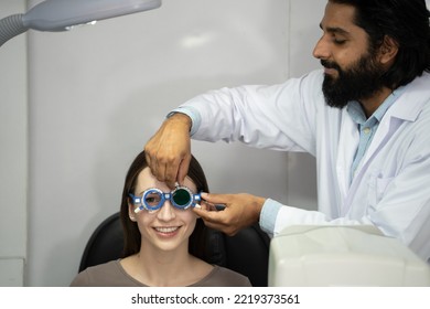 An Eye Doctor Examines A Woman Patient In A Clinic With Modern Equipment.