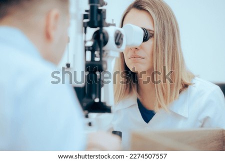 
Eye Doctor Examining a Patient for Correct Diagnosis. Female Ophthalmologist using medical equipment for correct diagnoses 
