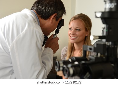 Eye Doctor With Female Patient During An Examination At The Office