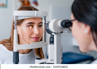Eye doctor with female patient during an examination in modern clinic - Shutterstock ID 1565916823