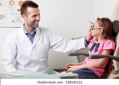 Eye Doctor, Optometrist Working With Young Girl