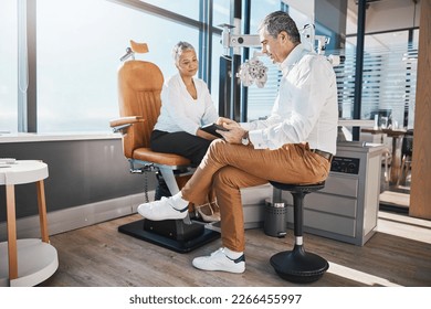 Eye doctor, tablet or senior woman consulting for help with eyesight at optometrist for an assessment. Optician talking or asking customer questions to check vision, iris or retina health in office - Powered by Shutterstock