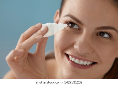 Eye Drop. Woman Applying Lubricant Eye Drops In Her Eyes Closeup. Happy Smiling Girl With Artificial Tears Bottle