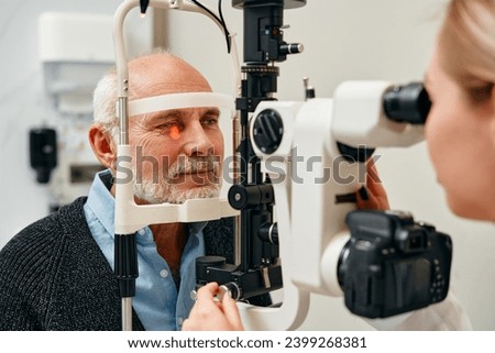 Eye exam of mature men consulting doctor for eyesight at optometrist or ophthalmologist. Face of senior customer testing vision with optician helping or testing iris or retina visual health.