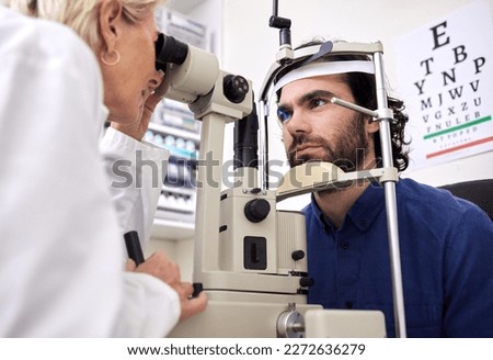 Eye exam, vision test and patient with laser lens and doctor at optometry consultation. Face of a man and woman healthcare person with machine for eyes, wellness and health insurance with expert care