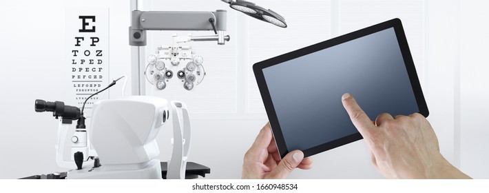 eye examination test concept, hands touch screen of digital tablet, ophthalmology and optometry equipment on background - Powered by Shutterstock