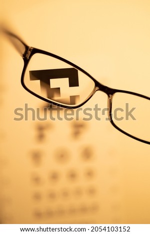 Eye Glasses and Out of Focus Eye Chart