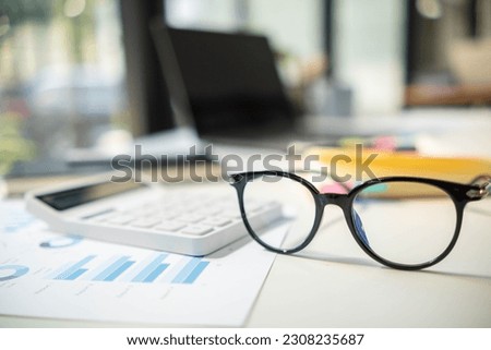 eye glasses placed on the desk are eye glasses that are prepared for people with farsightedness to work and read documents clearly. The concept of wearing eye glasses for normal vision