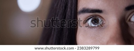 Eye, half and portrait of face of woman with a stare, serious and looking intense isolated in blurred background. Angry, mad and mysterious person or female at night, evening or late with mockup