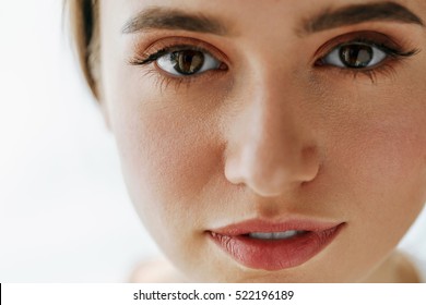 Eye Health And Care. Portrait Of Girl Face With Smooth Healthy Skin And Perfect Natural Makeup. Closeup Of Beautiful Woman With Big Brown Eyes And Eyebrows On White Background. High Resolution Image