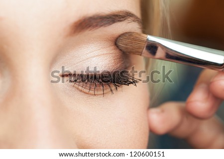 Eye makeup woman applying eyeshadow powder