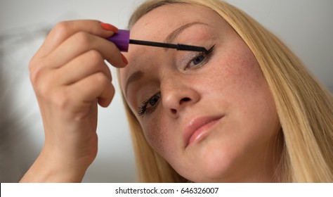 Eye makeup.Young woman applying mascara make-up