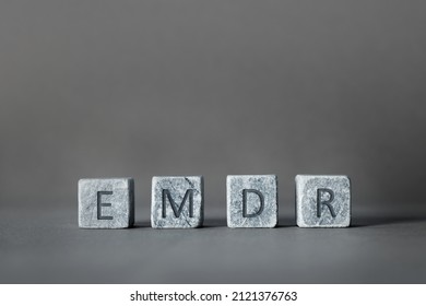 Eye Movement Desensitization and Reprocessing psychotherapy treatment concept. Letters EMDR written on grey stone cubes blocks. - Shutterstock ID 2121376763