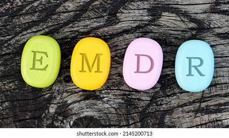 Eye Movement Desensitization and Reprocessing psychotherapy treatment concept. Letters EMDR written on colorful wooden stone blocks. - Shutterstock ID 2145200713