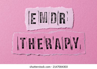 Eye Movement Desensitization and Reprocessing psychotherapy treatment concept. Letters EMDR and therapy written on torn paper. - Shutterstock ID 2147004303