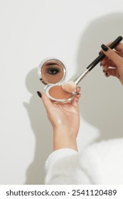 Eye reflection in mirror during makeup application – artistic composition