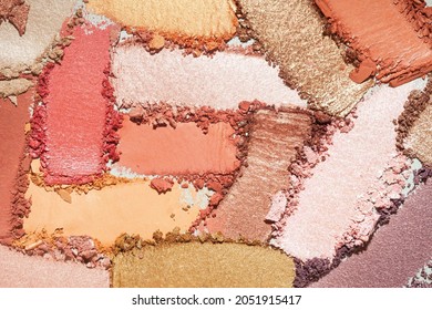 Eye shadow multi colored brown beige, orange, golden, pink smudge loose gray isolated background