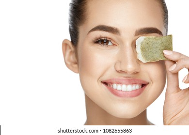 Eye Skin Care. Beautiful Woman With Green Tea Bag Under Eyes