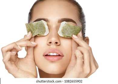Eye Skin Care. Beautiful Woman With Green Tea Bag Under Eyes