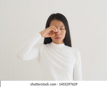 eye socket pain in asian woman cause from the infection of the sinuses cavities or migraines and cluster headaches use for health care concept.